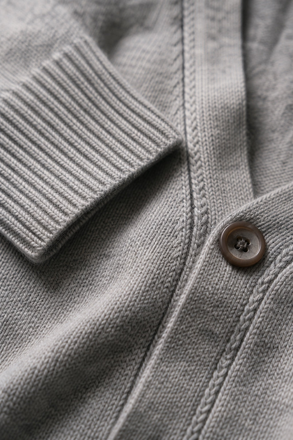 Cashmere rib cuff seam and button detail